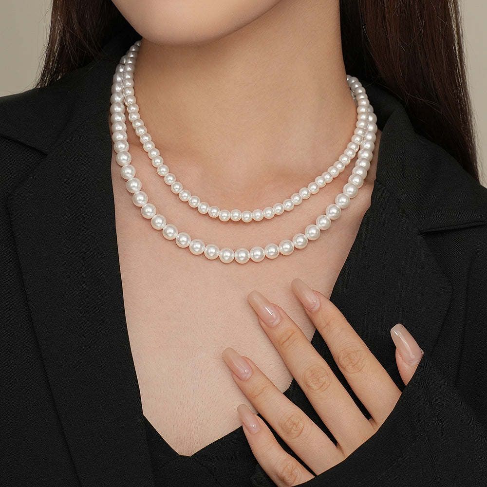 Sterling silver round bead necklace seen from the side, polished bead on a thin chain