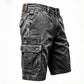 Washed cotton denim mens cargo shorts, detail of the plain hem just above the knee
