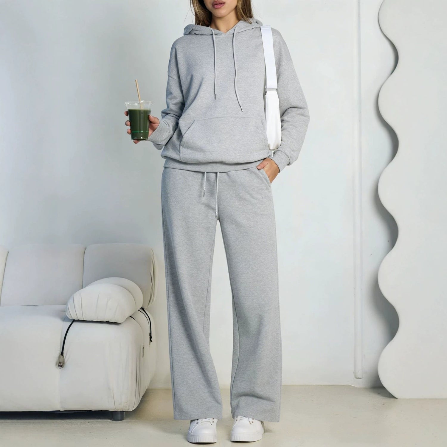 Light gray fleece hooded sweatshirt and wide-leg sweatpants set worn by a model