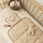 Close view of the quilted cotton surface and bias binding on the changing pad