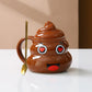 Brown ceramic poop emoji mug beside a small matching spoon and a printed gift bag