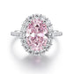 The pink stone ring photographed flat, showing the full halo and the pave line down each shoulder