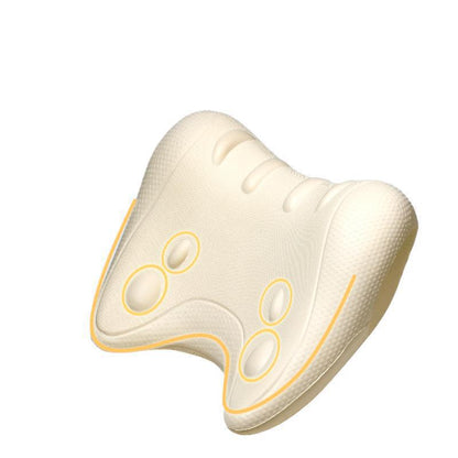 Ivory contoured foam neck pillow with raised oval nodes outlined in gold on a white background