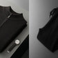 Black knit zip cardigan folded flat beside black jogger trousers and a watch, size XL option