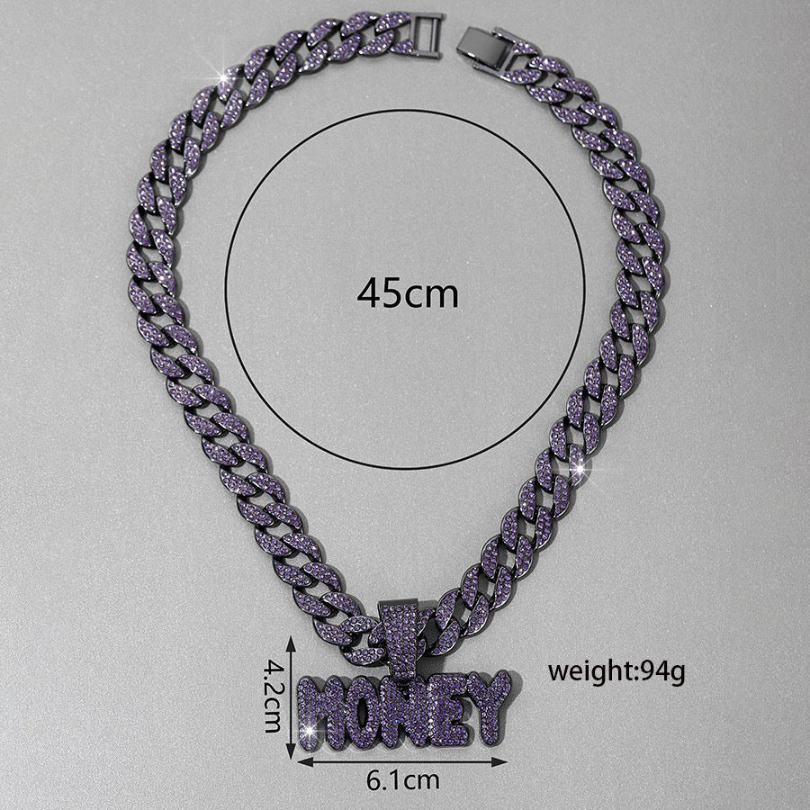 Money letter pendant held to show its size in the hand