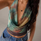 Sleeveless green geometric print blouse shown from the side