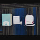 Top view of a box, paper roll, cable and a pink cat ear thermal printer on a dark mat, C9 pink option