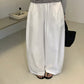 Model in white cotton wide leg trousers with drawstring waist and flat sandals
