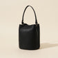 Genuine leather bucket bag in Dark Gray, front view of the rounded cowhide body