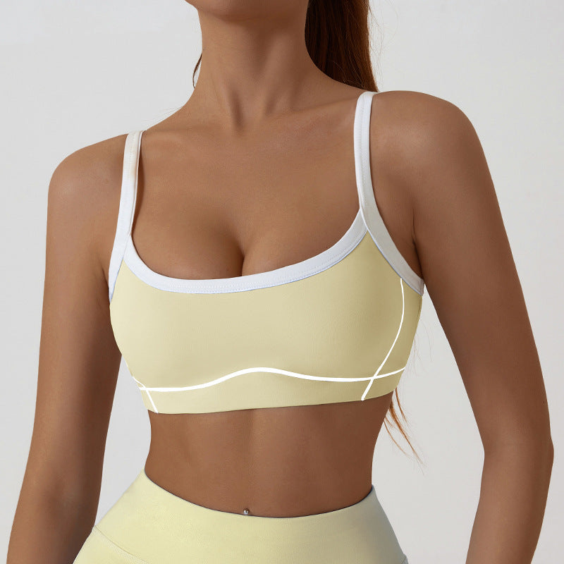 Back view of the sports bra with thin spaghetti straps crossing low across the shoulders