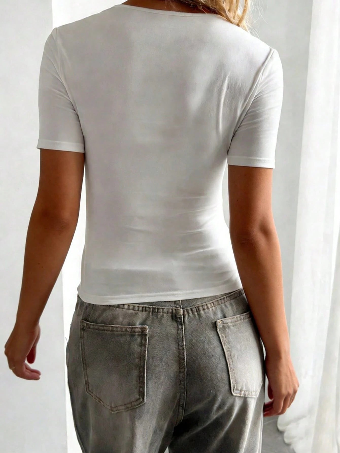 Back view of white slim fit short sleeve top