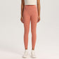 Ankle-length high-waisted yoga leggings in a matte nylon spandex knit on a model