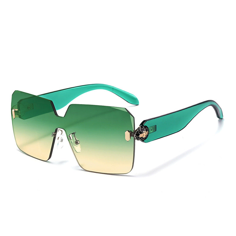 Rimless snake head sunglasses photographed flat with both arms folded in