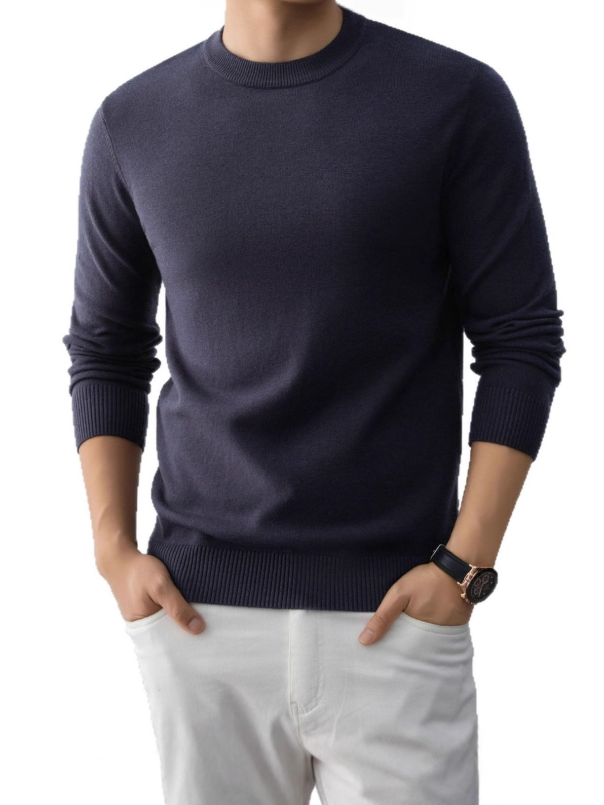 Navy blue slim fit crew neck knit sweater with ribbed cuffs and hem on a model wearing white trousers