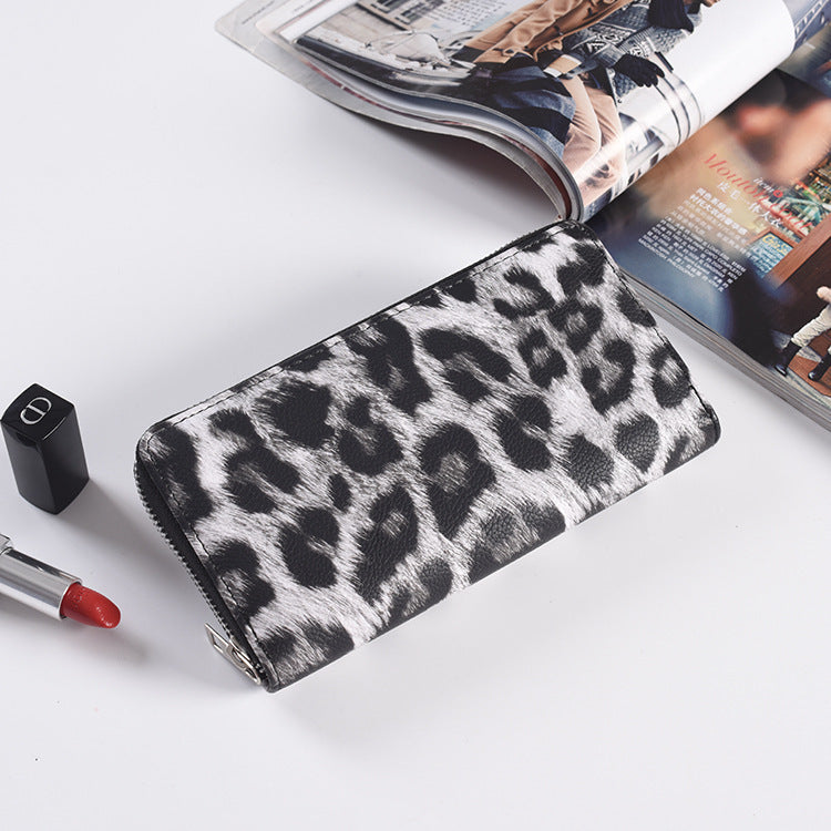 Snow leopard print long wallet with a full edge zip and slim flat profile