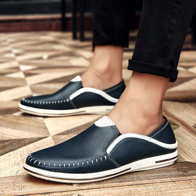 Slip on cowhide leather loafer shown on foot with cropped trousers on a paved street