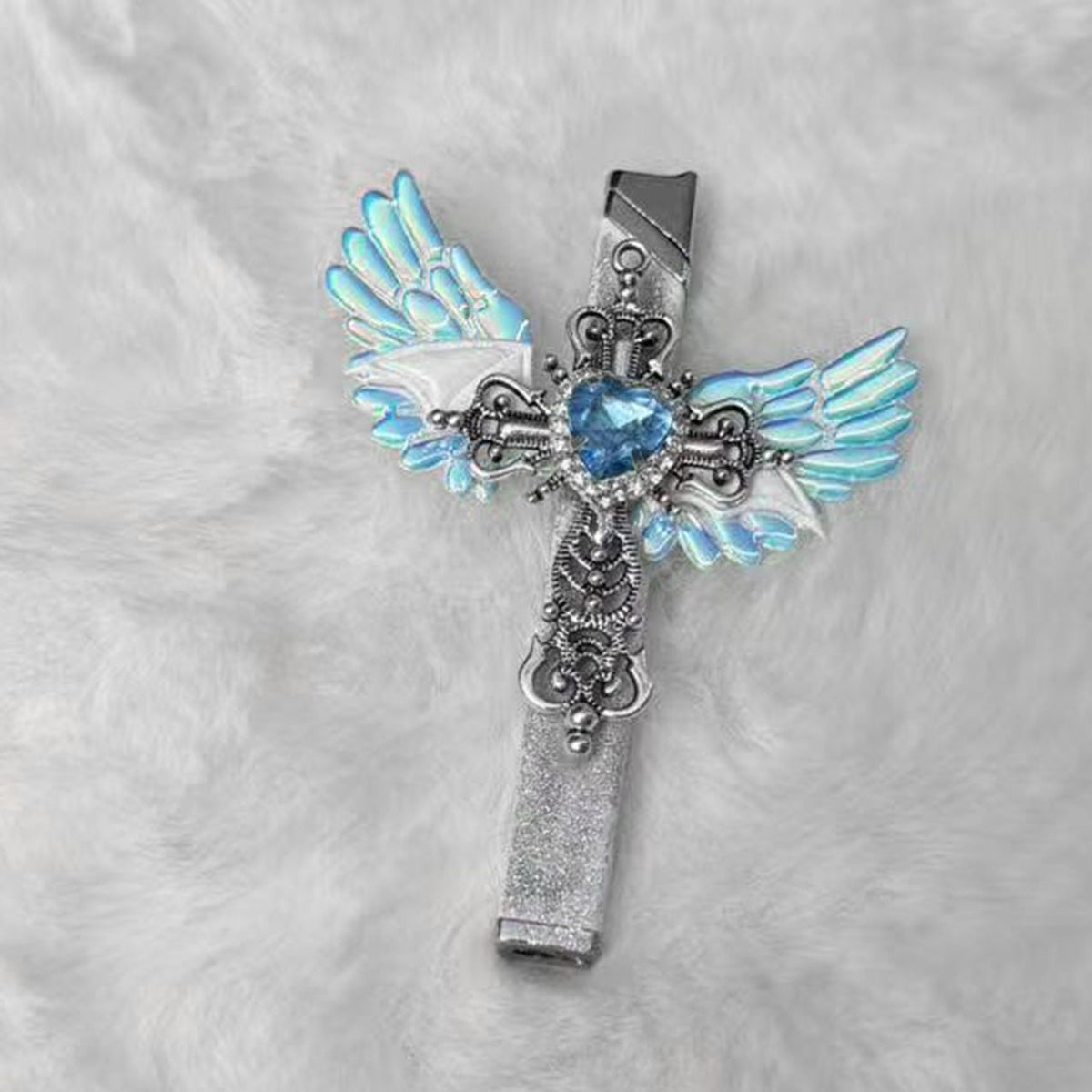 Angel wings cross lighter on white fur with iridescent blue wings and a glittering silver body