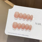 Front view of peach milk French-style press-on nails with a soft gradient tip