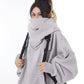 Grey oversized hooded sweatshirt with the high collar pulled up over the mouth, worn with a backpack, size option M