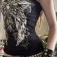 Side view of the black tube top showing the winged cross print with roses on the front and a slim fit