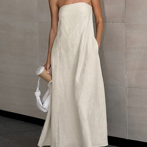 Back view of khaki strapless linen maxi dress showing side pocket and long skirt