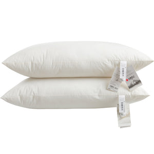 Two white cotton bed pillows stacked flat, 48 by 74 cm, with paper care tags attached