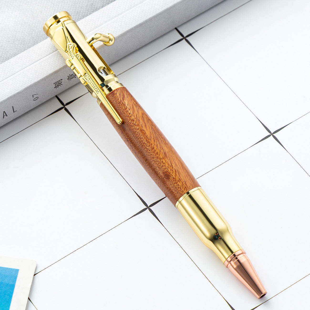 Bolt action ballpoint pen with its rifle style metal bolt lever shown on a plain surface