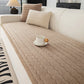 Non slip lambswool sofa seat cover shown on a light sofa