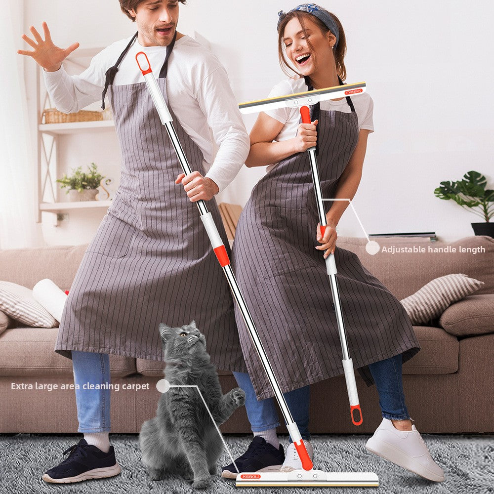 Man and woman in aprons holding long handle pet hair removers in a living room with a cat, long handle versions shown