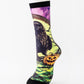 Mid-calf sock on a mannequin printed with a dark raven beside a glowing pumpkin on green and yellow