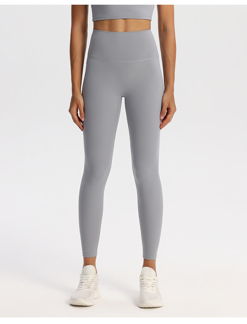 Solid-tone high-waisted yoga leggings for women in a nylon spandex knit, on a model