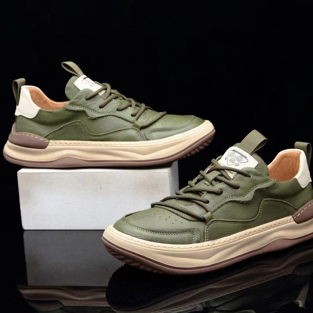 Green lace up sneakers displayed on a white block, pale midsole wrapping the shoe