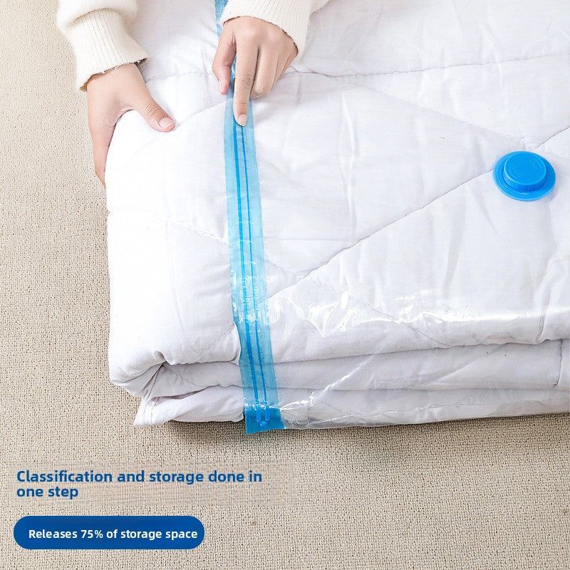 Hand sliding the zip seal closed on a clear vacuum storage bag holding a white duvet, blue valve visible