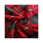 Swirled red, green and black tartan coral fleece fabric in a close up of the plaid pattern