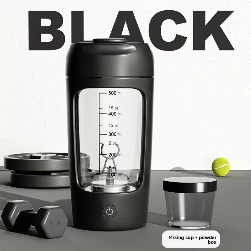 Electric protein shaker cup with a printed scale, held in one hand