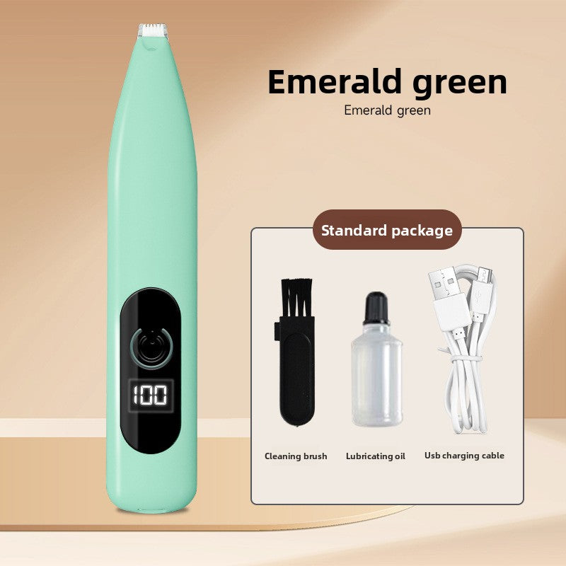 Emerald green pet paw trimmer beside the maker standard package of brush, oil bottle and USB cable