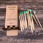 Soft bristled bamboo toothbrushes laid out on a clean studio background