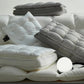 White and grey quilted bed pillows with mesh gusset side bands on bedding