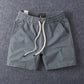 Grey men's cotton drawstring shorts showing the elastic drawstring waistband