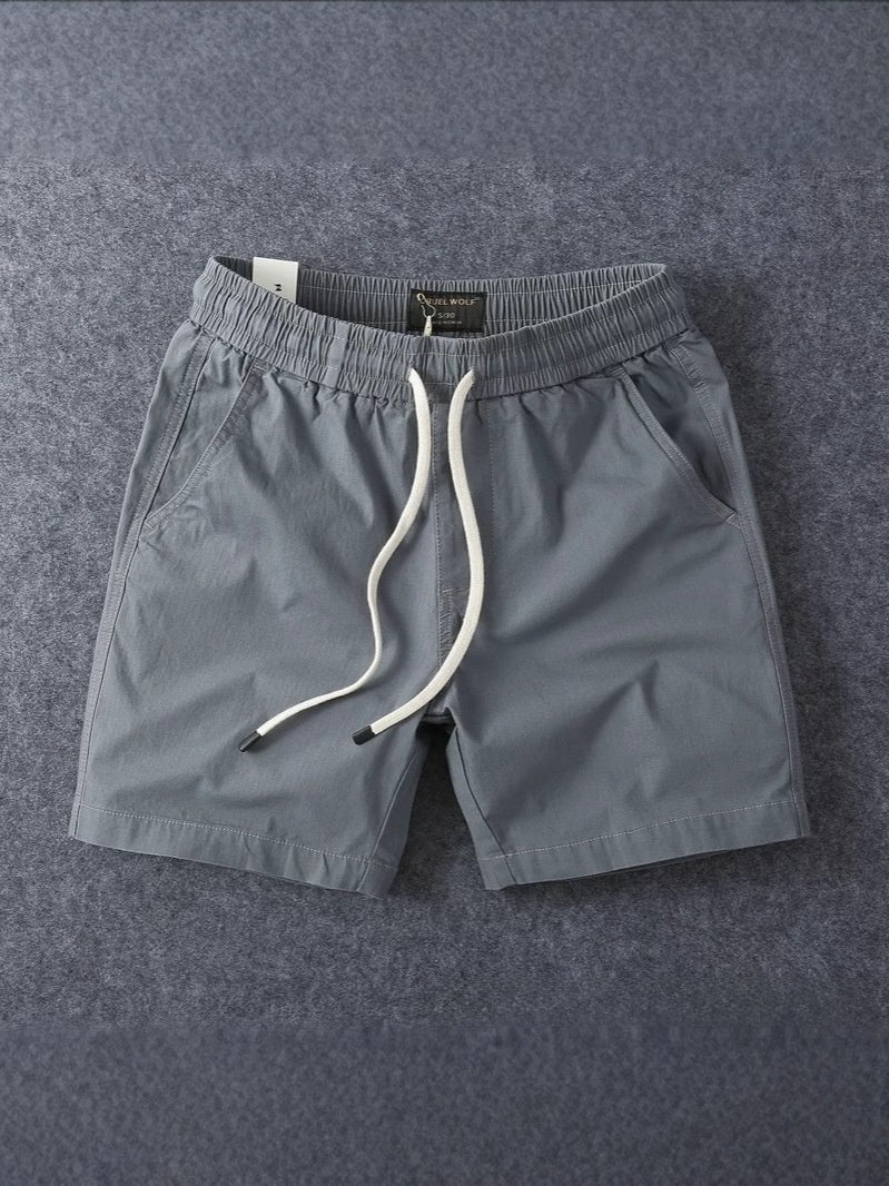 Grey men's cotton drawstring shorts showing the elastic drawstring waistband