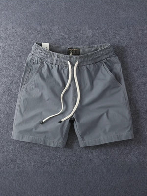 Grey men's cotton drawstring shorts showing the elastic drawstring waistband