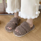 Close view of the faux fur footbed and low PVC sole of the open toe slipper