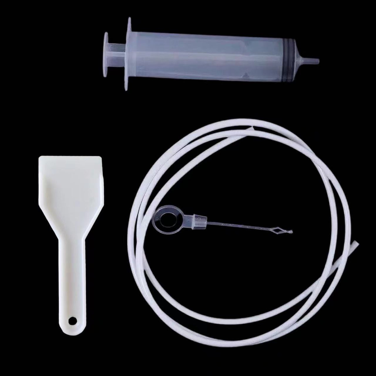 4pcs Bagged option: syringe, scraper, white tube and plug pin on a black background