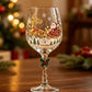 Clear wine goblet with a second painted holiday sled design on the bowl