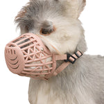 Beige ventilated basket dog muzzle worn by a small grey and white dog