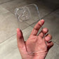 Clear hard phone case with a raised camera ring held in a hand, iPhone 15 Plus option