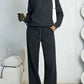 Dark gray fleece hooded sweatshirt and wide-leg sweatpants set worn by a model