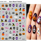 Halloween nail decals shown as a finished manicure with skulls and pumpkins