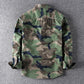 Men's washed camouflage long sleeve button shirt with two flap chest pockets front view of the green camo colourway