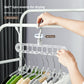 Hand turning the 360 degree rotating hook of a clear nine-hole hanger rack loaded with shirts